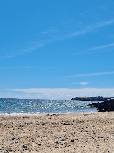 Background image of Helvick Head seen from Clonea Strand